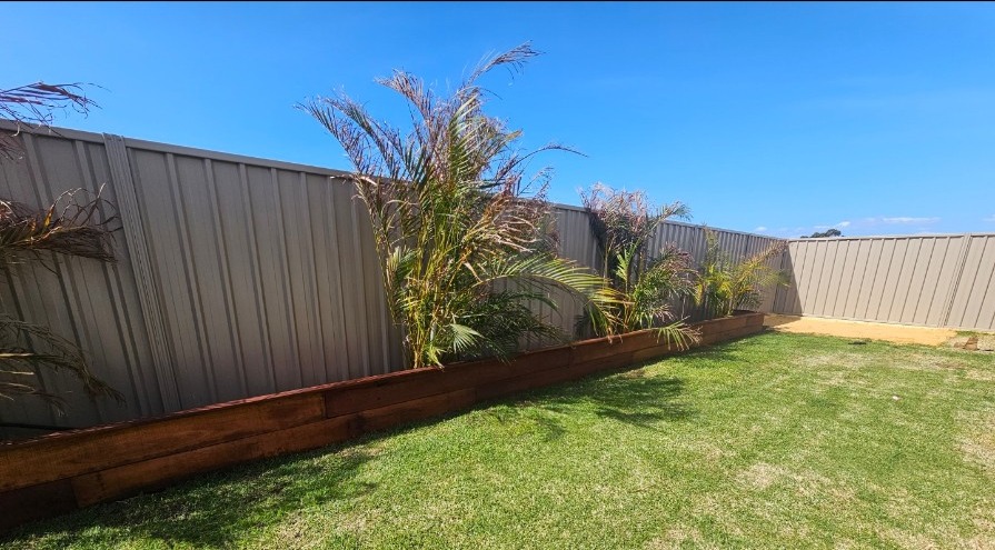 Completed Karnup garden bed with palms and timber edging